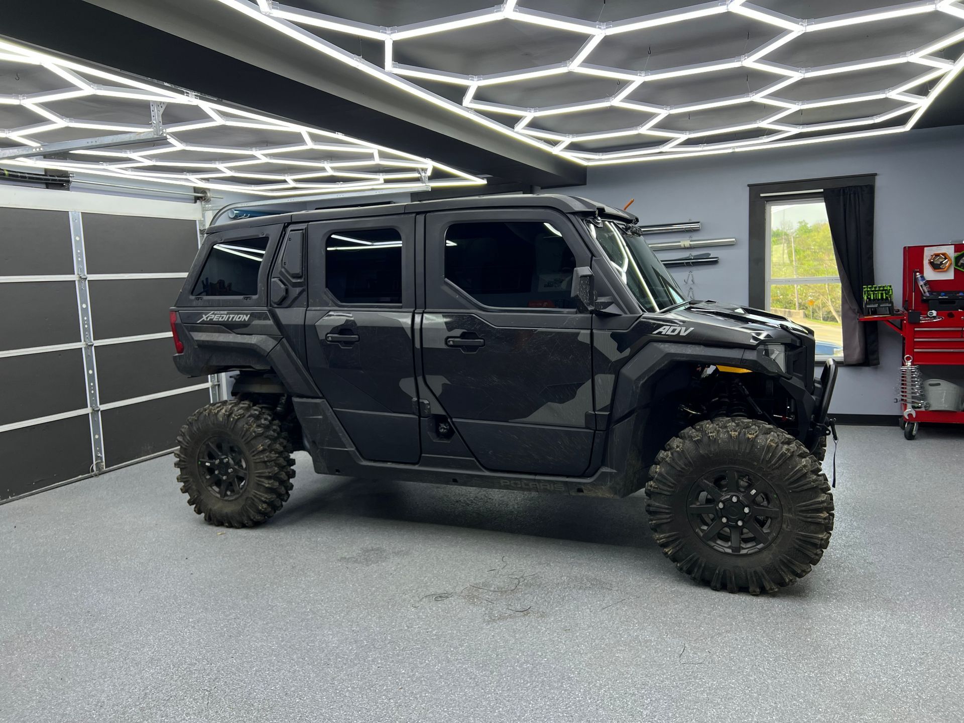A black car is parked in a garage.