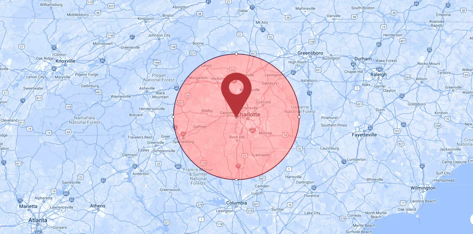 A map with a red pin in the middle of it.
