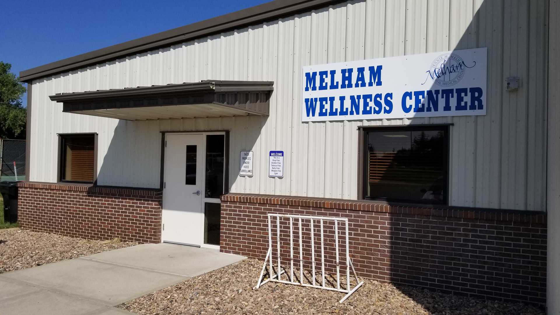 a white building with a sign that says Melham Wellness Center