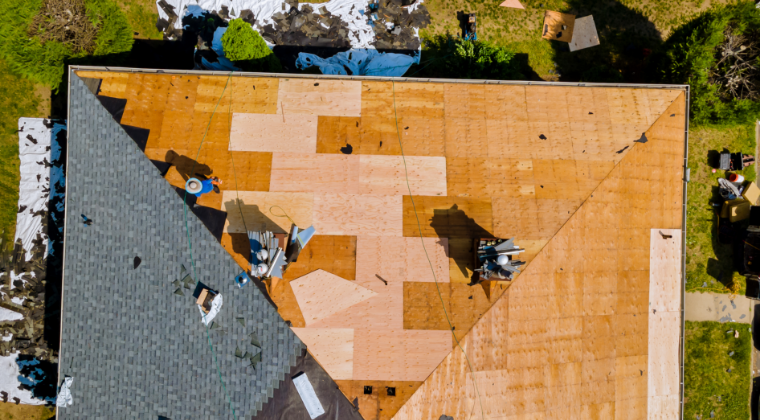 An aerial view of a roof being installed on a house.