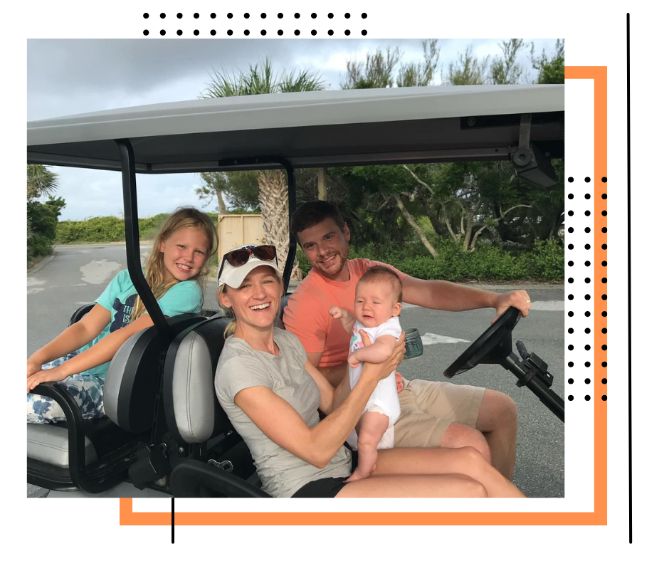 A family is sitting in a golf cart.