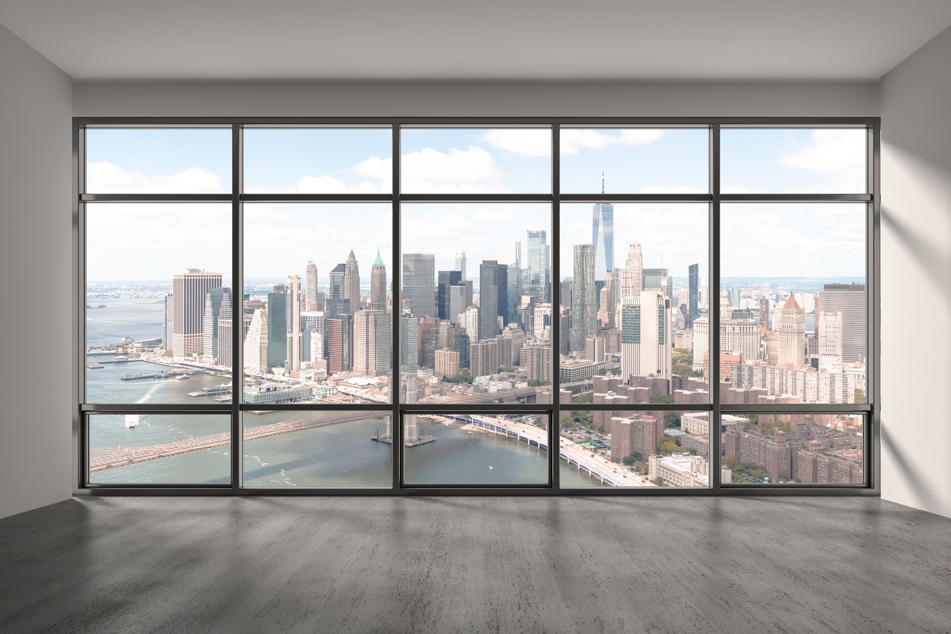 Large window overlooking a city skyline, showcasing tall buildings and a bridge. Interior setting with sunlight.