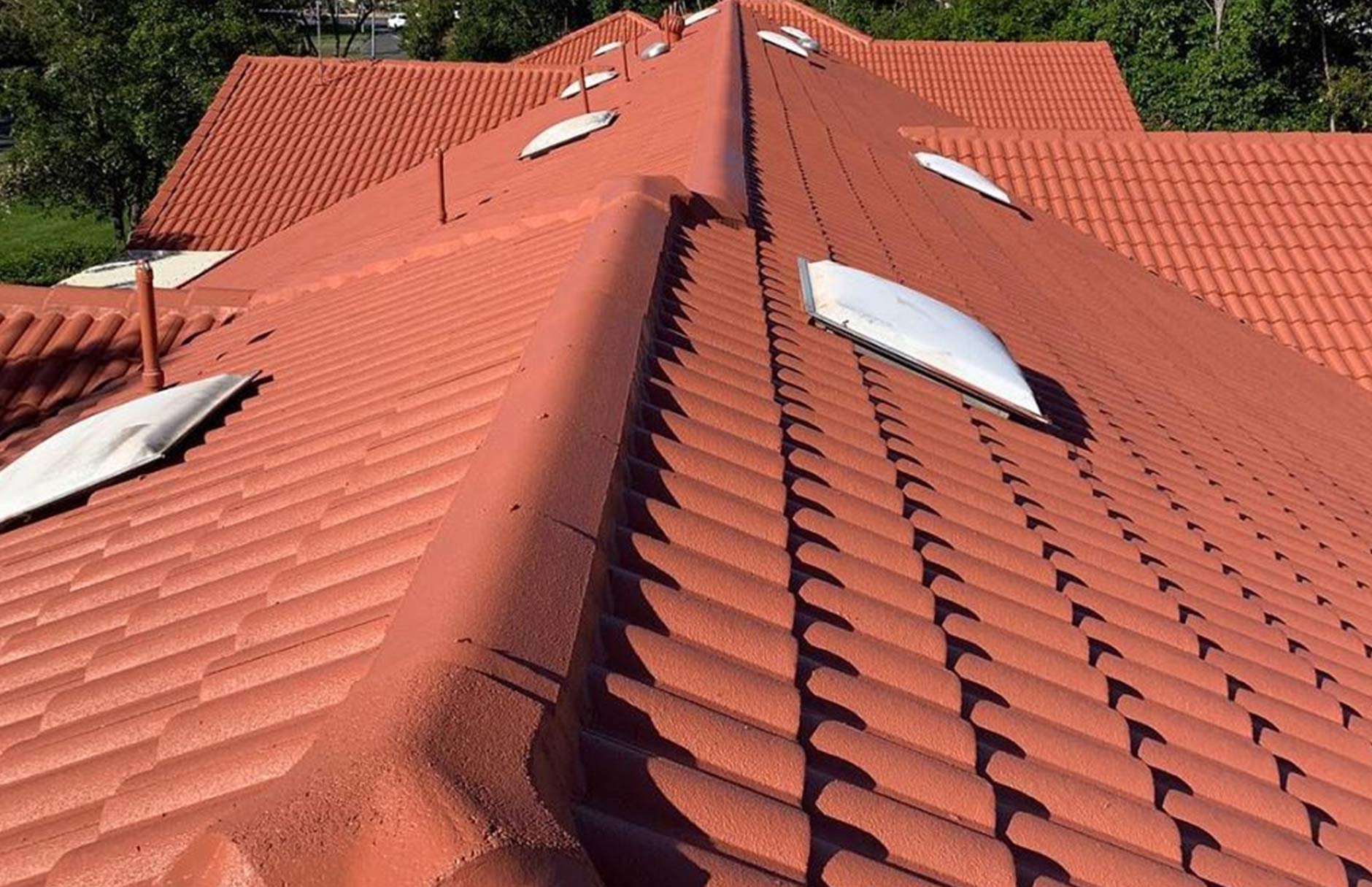 A red roof with a white skylight on it