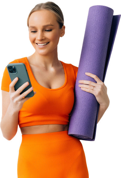 a woman holding a yoga mat and looking at her phone