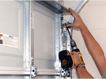 Contractor Installing Garage Door — Residential Garage Services in Cary, IL