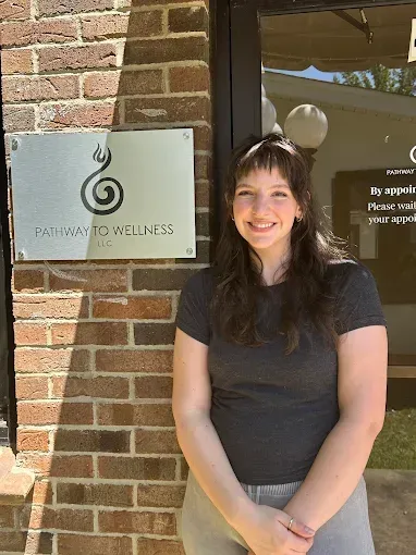 Woman smiling in front of a 