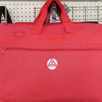 Red zippered tote bag hanging on a store pegboard display.