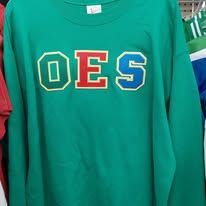 Green sweatshirt with large yellow, red, and blue “OES” letters on the front