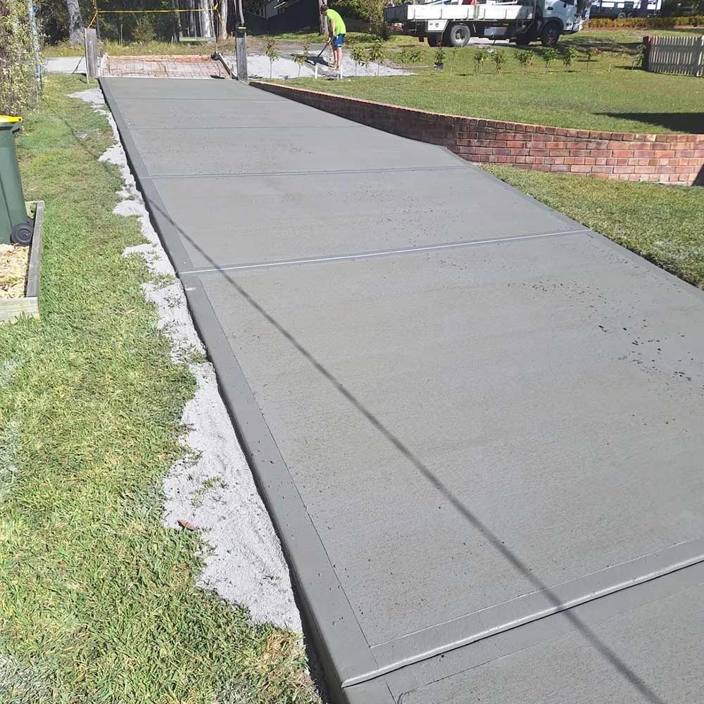 A Concrete Walkway is Being Built in a Yard — Dave Smith Concrete in Mallabula, NSW