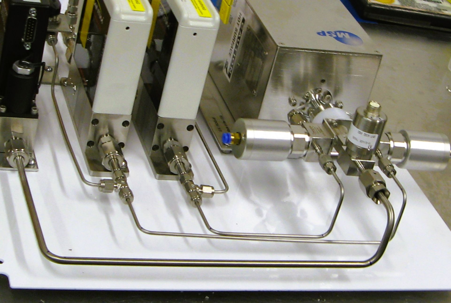 A bunch of metal pipes are connected to a machine