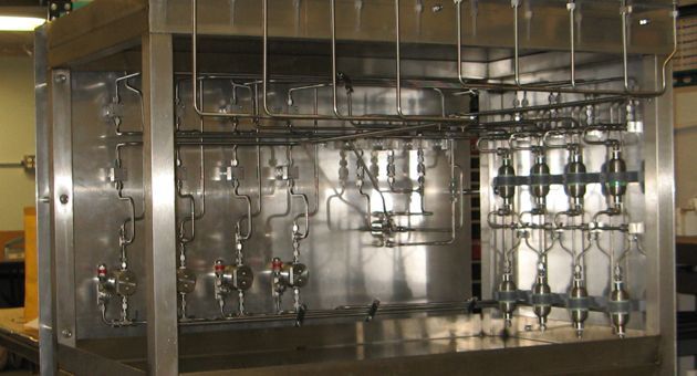 A large stainless steel machine is sitting in a room.