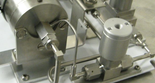 A close up of a stainless steel machine on a table.