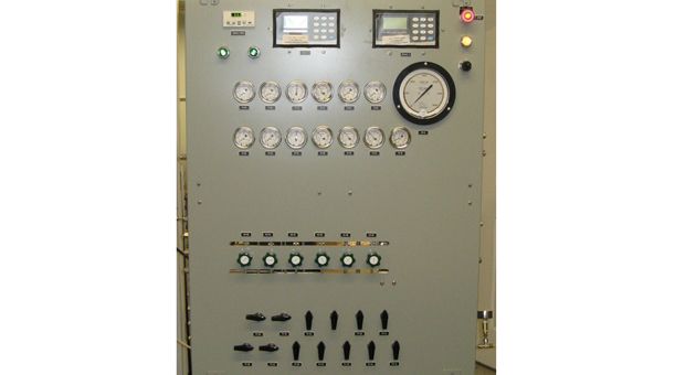 A control panel with a lot of buttons and gauges on it.