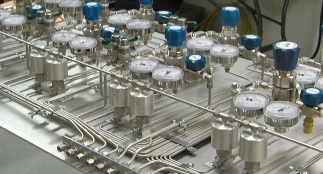 A machine with a lot of valves and gauges on it.