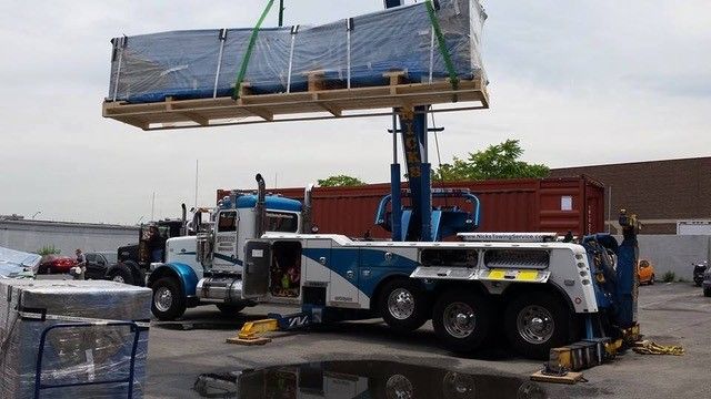 Nick’s Towing Service lifting large art crate in NJ—specialized crane and heavy-duty lifting services.