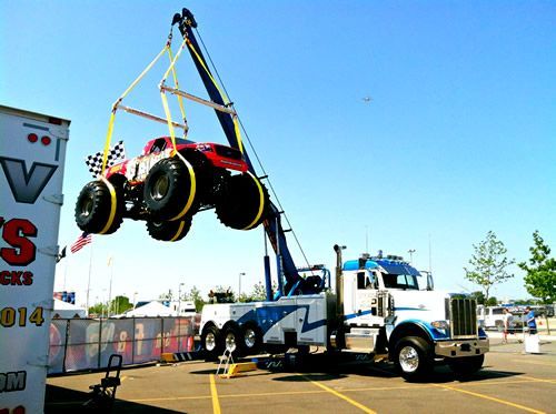 Monster truck lift by Nick’s Towing at NJ event—trusted for show vehicle transport and rigging services.