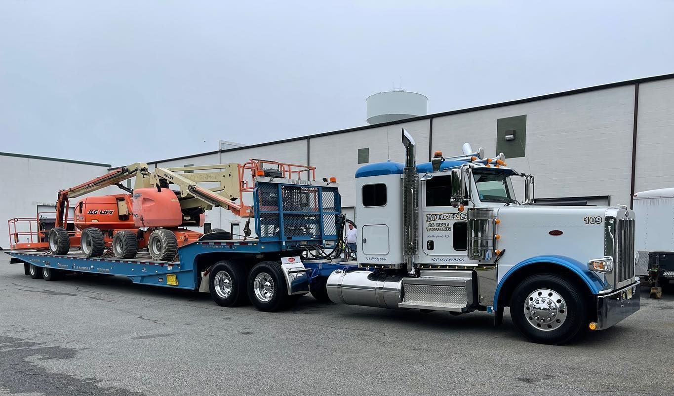 Nick’s Towing in Wallington NJ hauling boom lifts—heavy-duty transport in Bergen County and beyond.