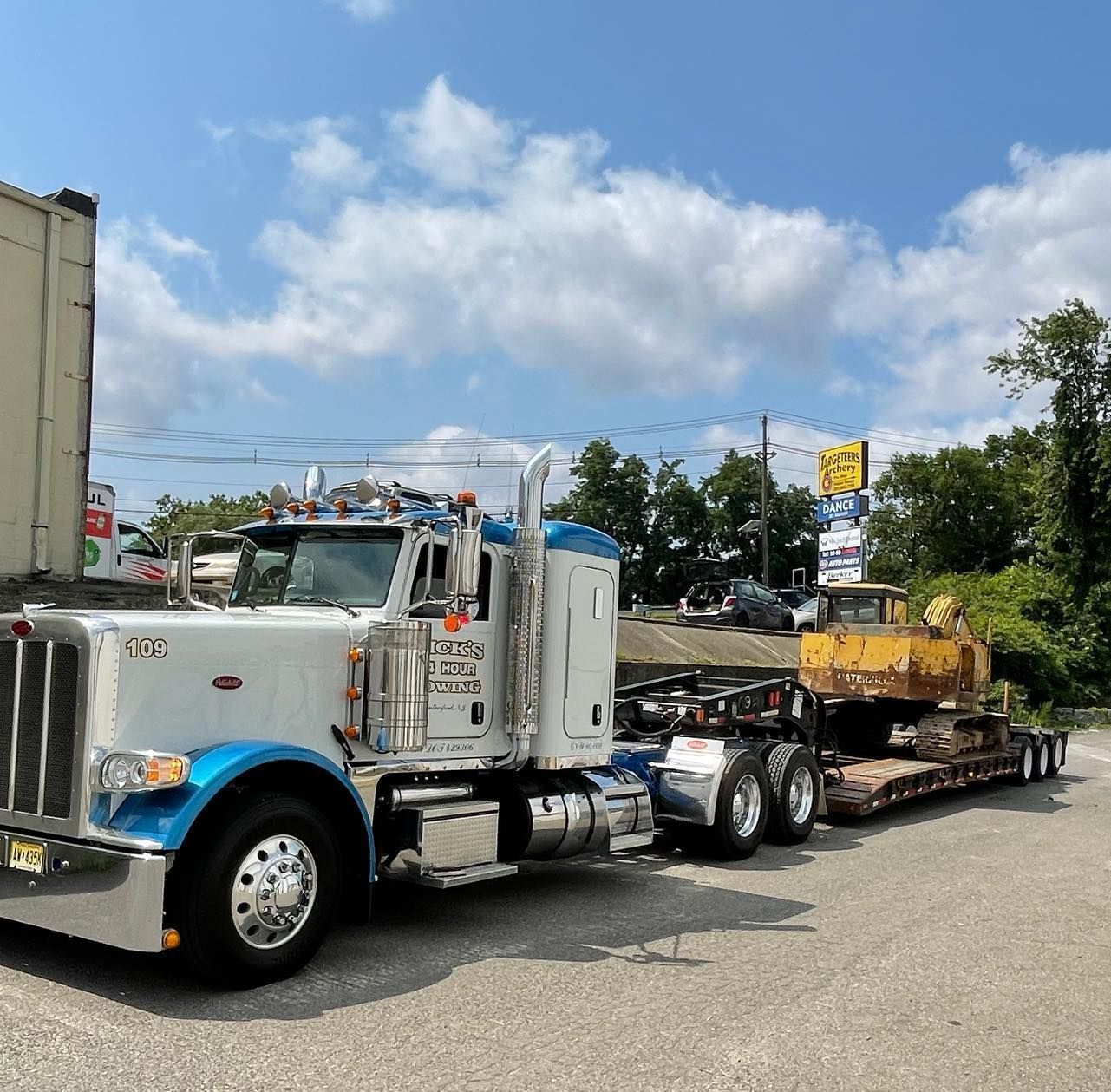 Nick’s Towing in NJ hauling heavy construction equipment safely with flatbed transport service