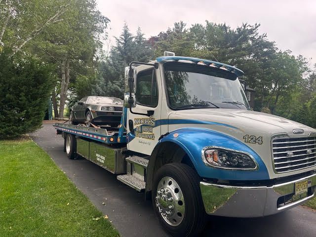 Nick’s Towing Service flatbed performing a light-duty vehicle tow in Rutherford, NJ.