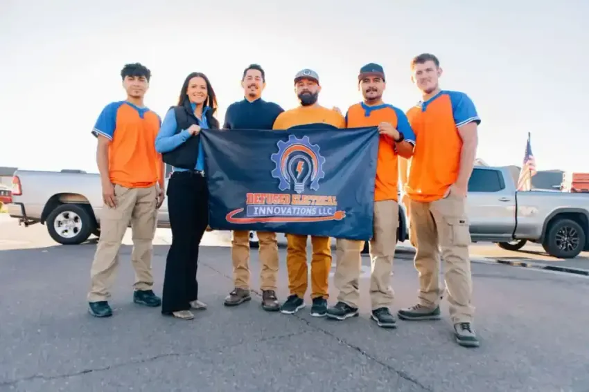 A group of people standing next to each other holding a flag.