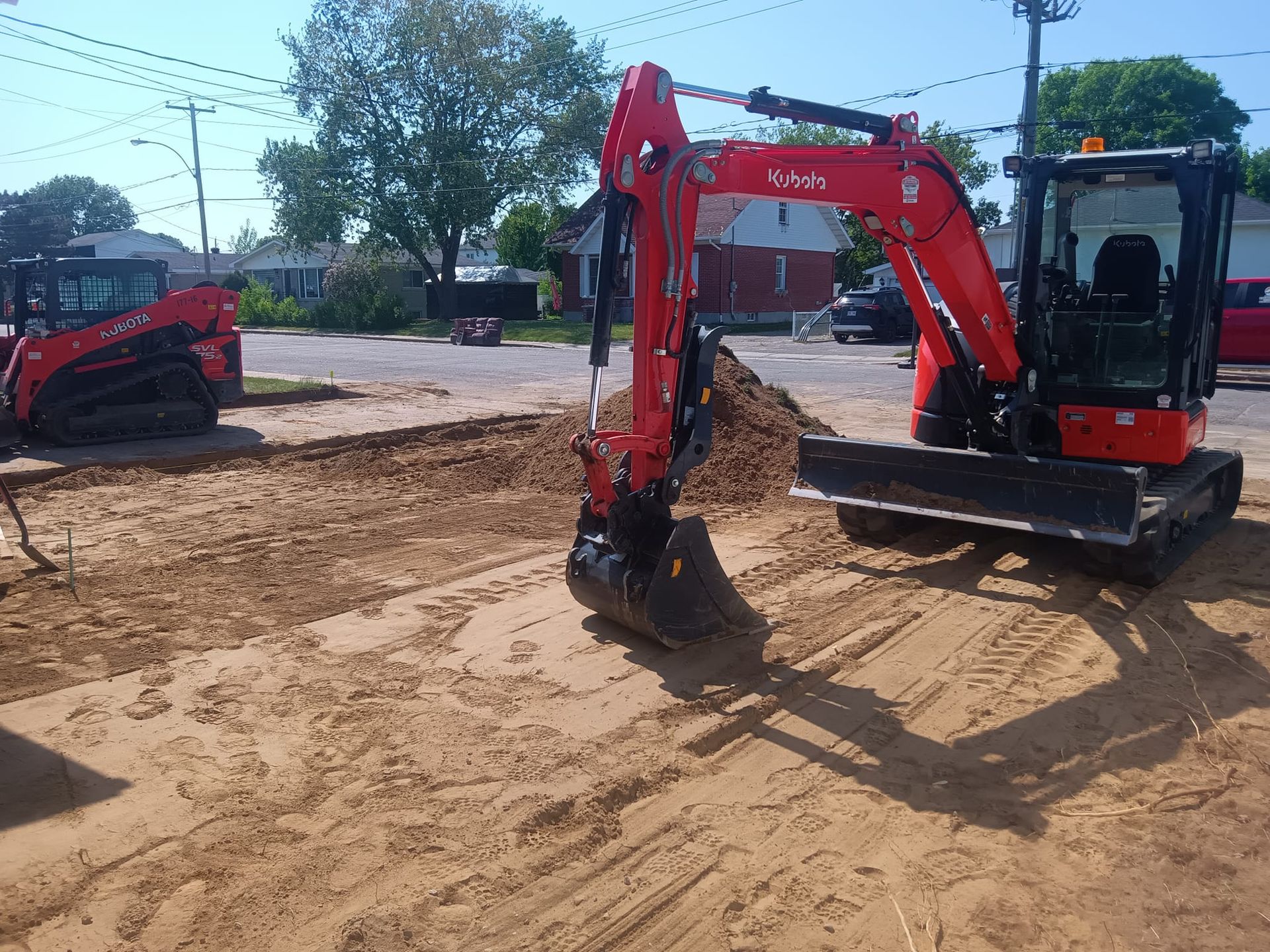 Une excavatrice rouge et noire creuse dans la terre