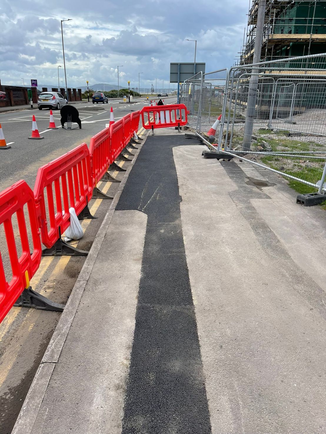 DP Cable Jointing | A sidewalk is being built on the side of a road.