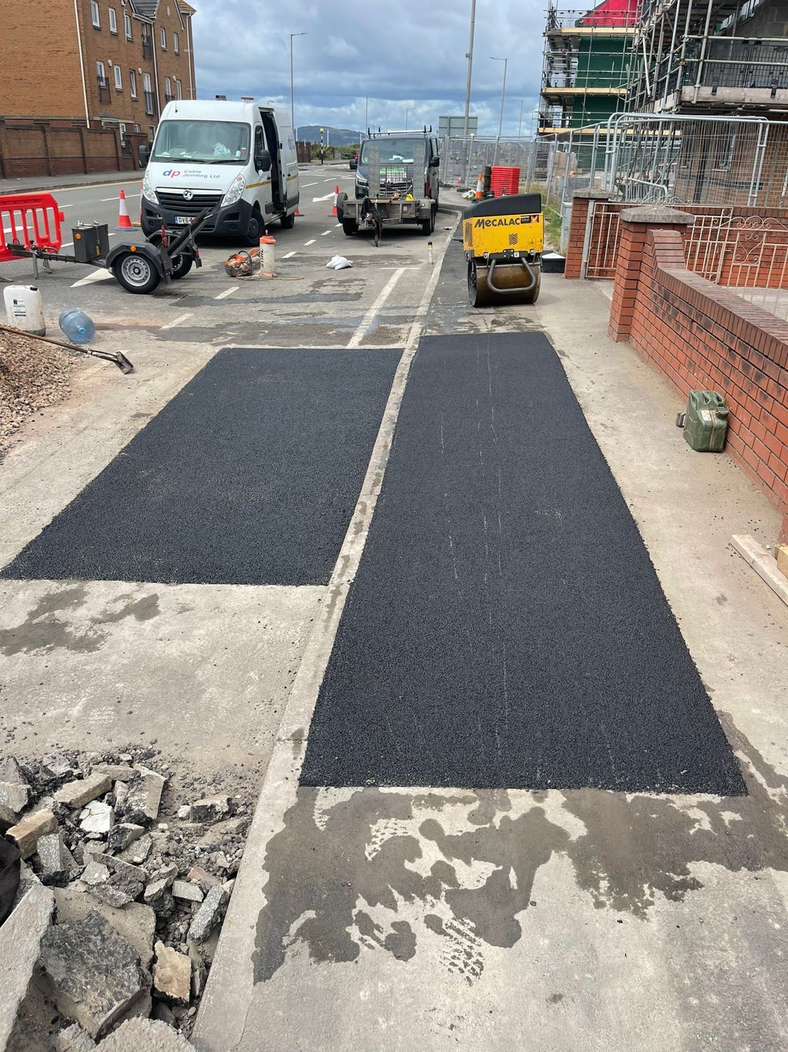 DP Cable Jointing | A construction site with a white van and a yellow dumpster.