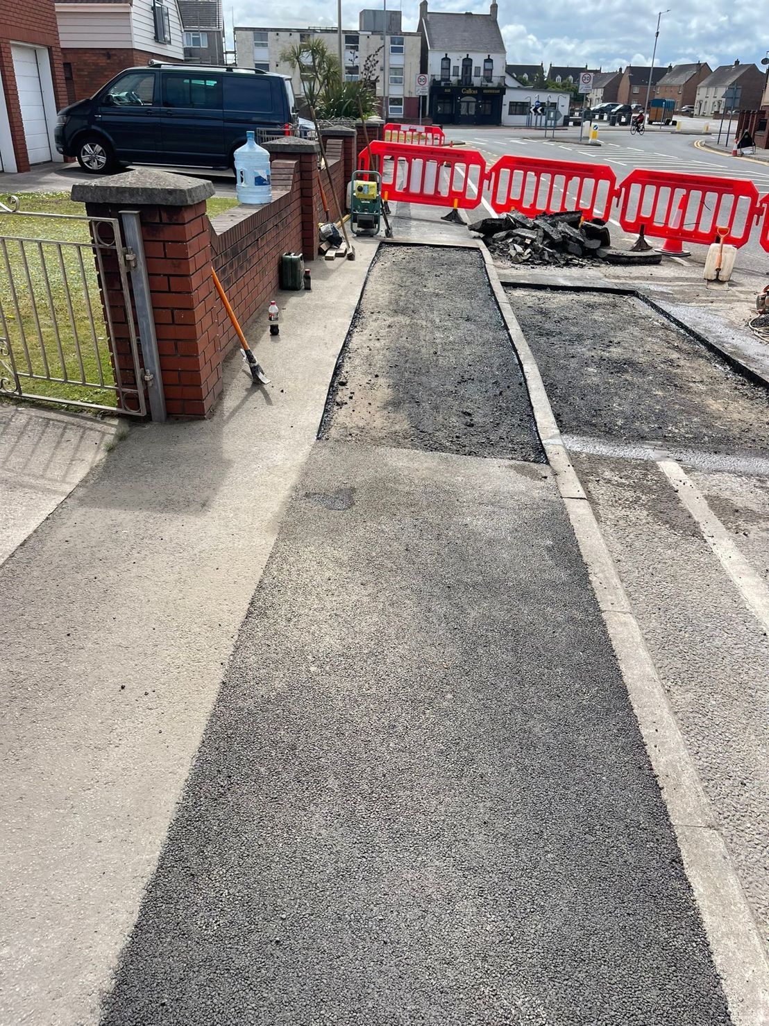 DP Cable Jointing | A brick wall is being built on the side of a road.