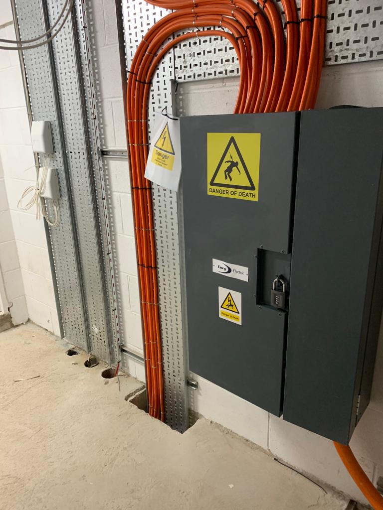 DP Cable Jointing | A gray box with a yellow triangle on it is surrounded by orange wires.