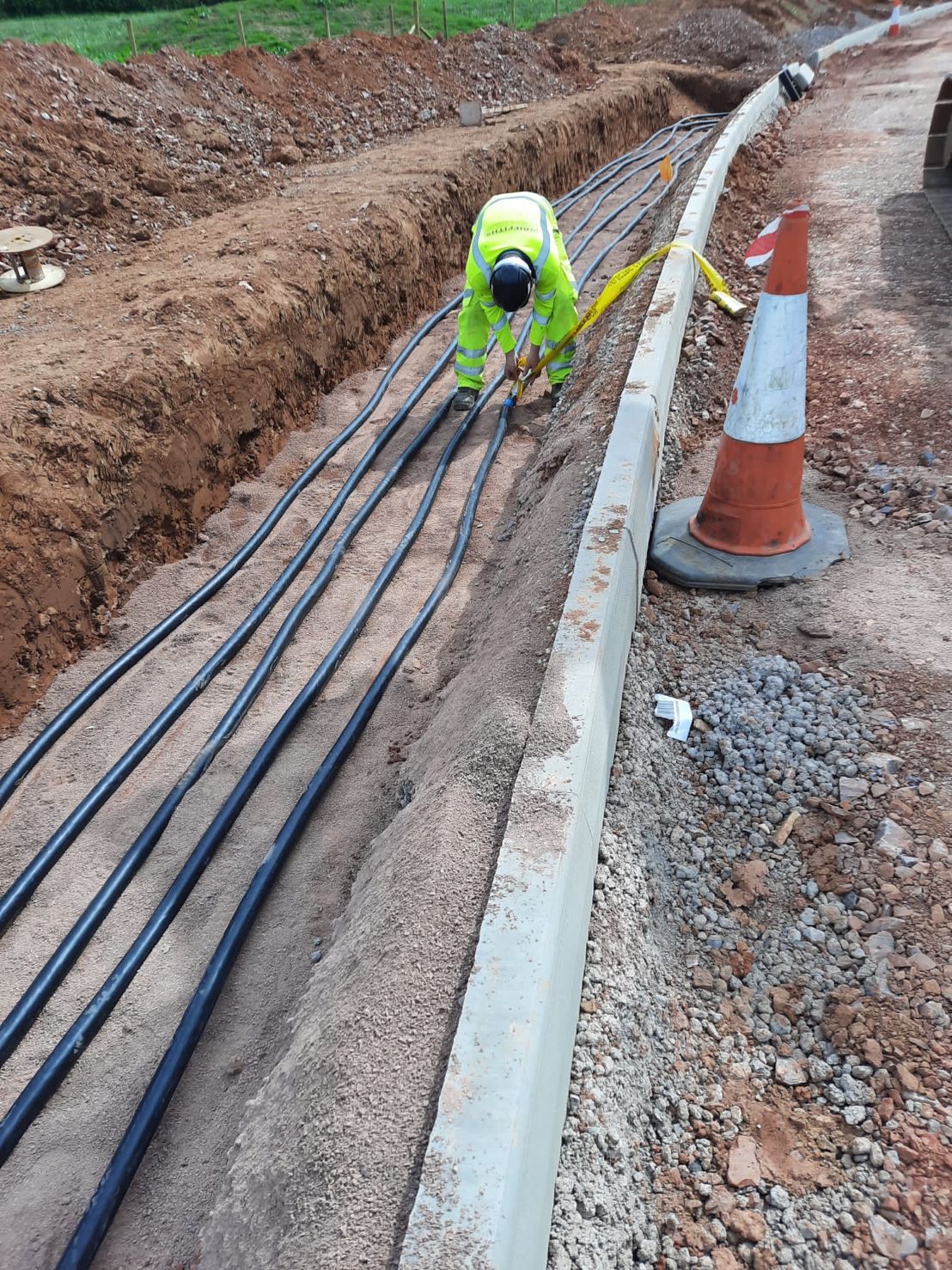 DP Cable Jointing | A man in a yellow vest is working on a road