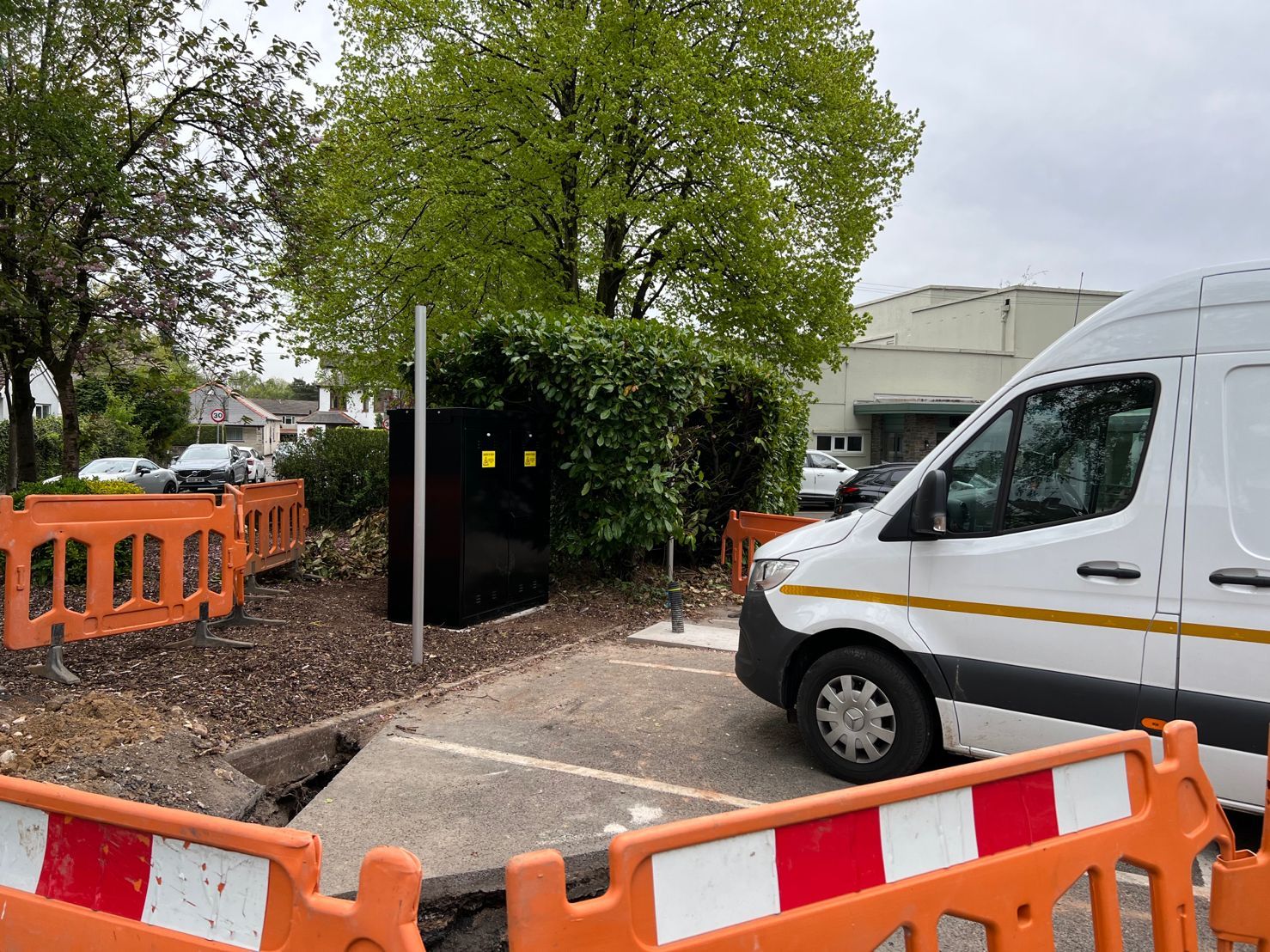 DP Cable Jointing | A white van is parked in a parking lot next to a fence.