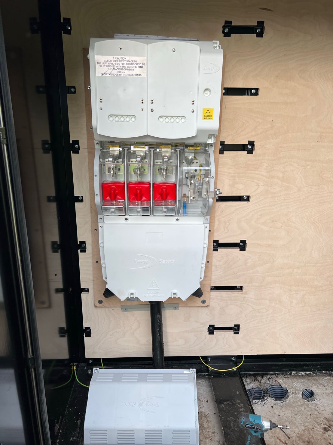 DP Cable Jointing | A large electrical box is sitting on a wooden wall.