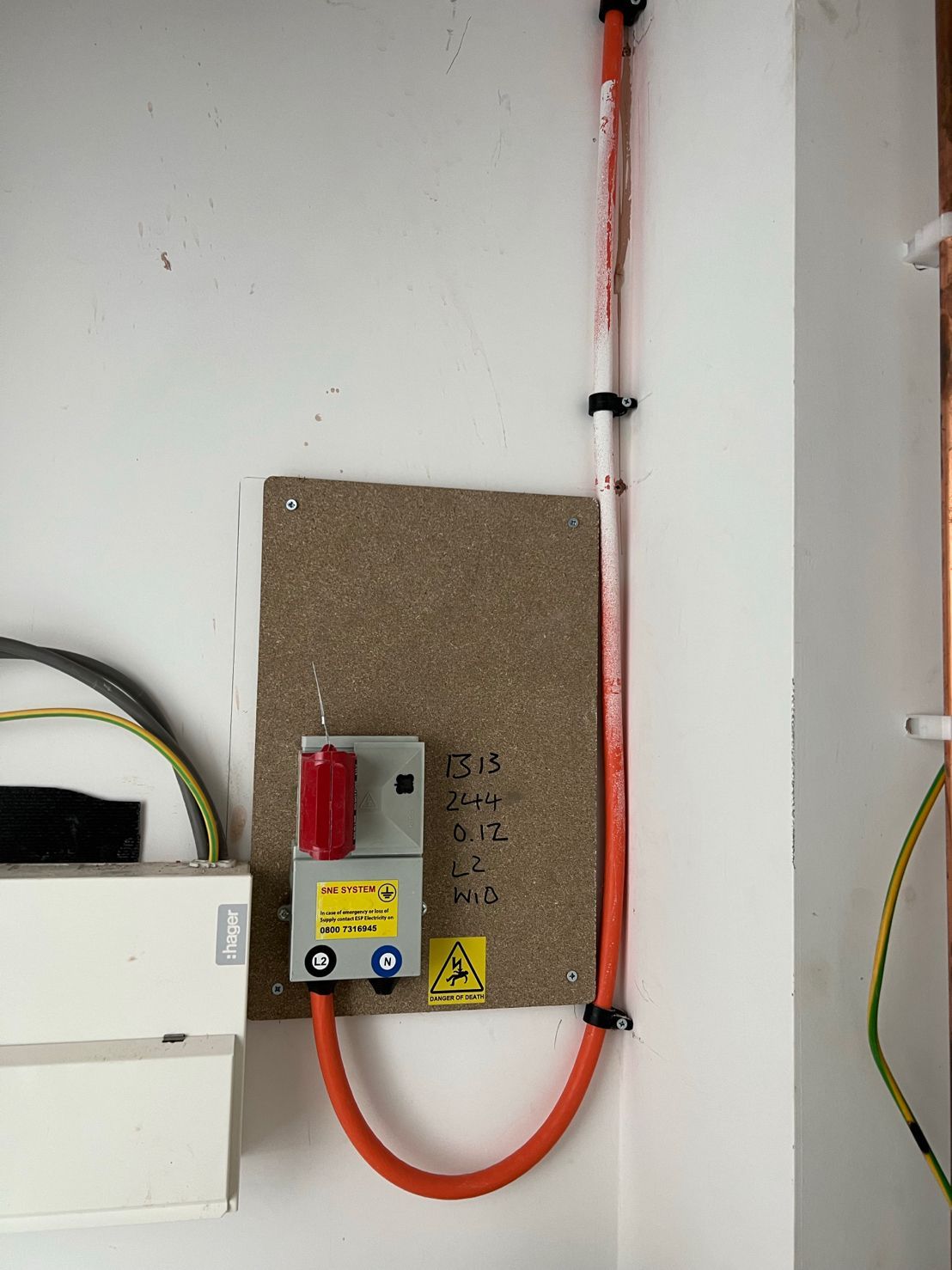 DP Cable Jointing | An orange hose is connected to a switch on a wall