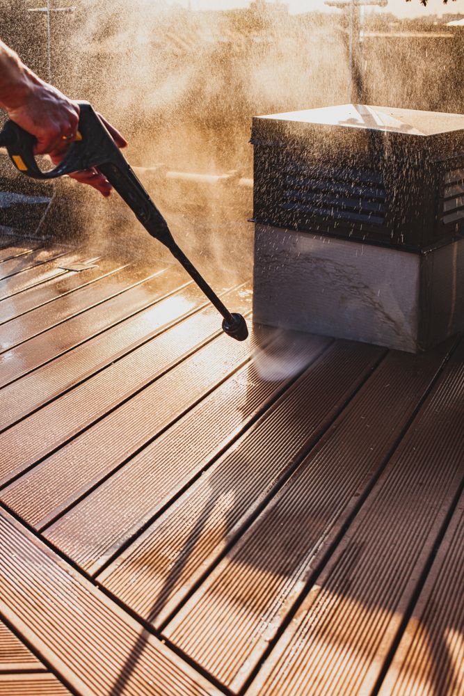 Pressure Washing a Wooden Deck, Spraying Water — Ericson Constructions in Mareeba, QLD