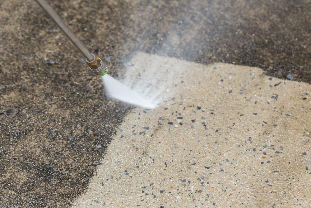 Pressure Washer Cleaning Concrete Surface — Ericson Constructions in Mareeba, QLD