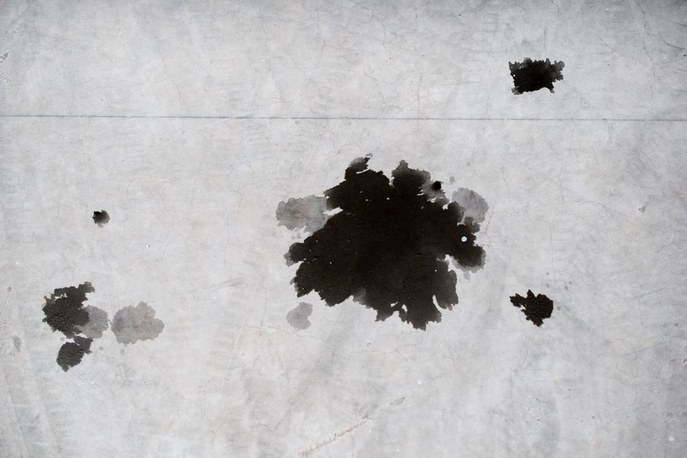 Oil Stains on a Gray Concrete Surface — Ericson Constructions in Mareeba, QLD