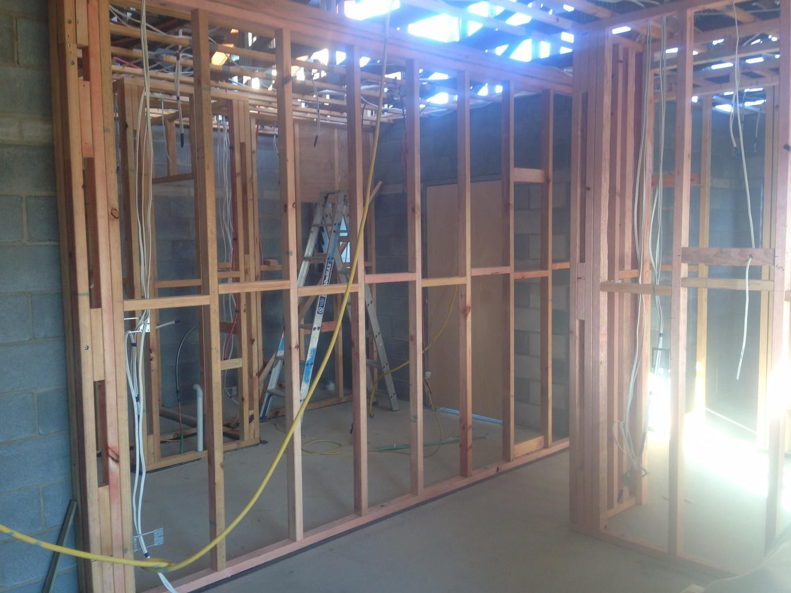 Wooden Wall Framing With Electrical Wiring in Unfinished Construction — Ericson Constructions in Mareeba, QLD