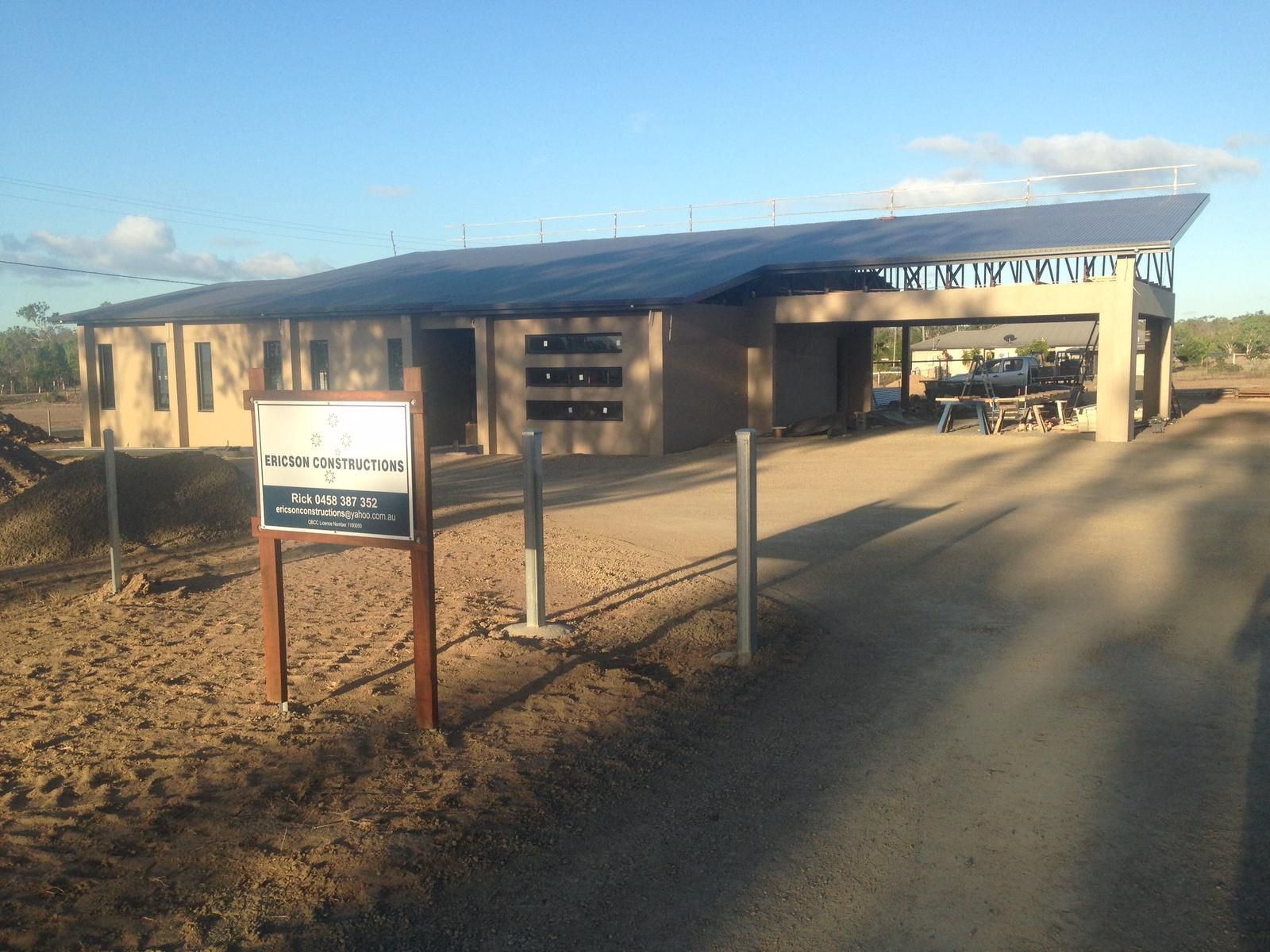 Building With Solar Panels and a Covered Area, Sign in Front, Dirt Path — Ericson Constructions in Mareeba, QLD