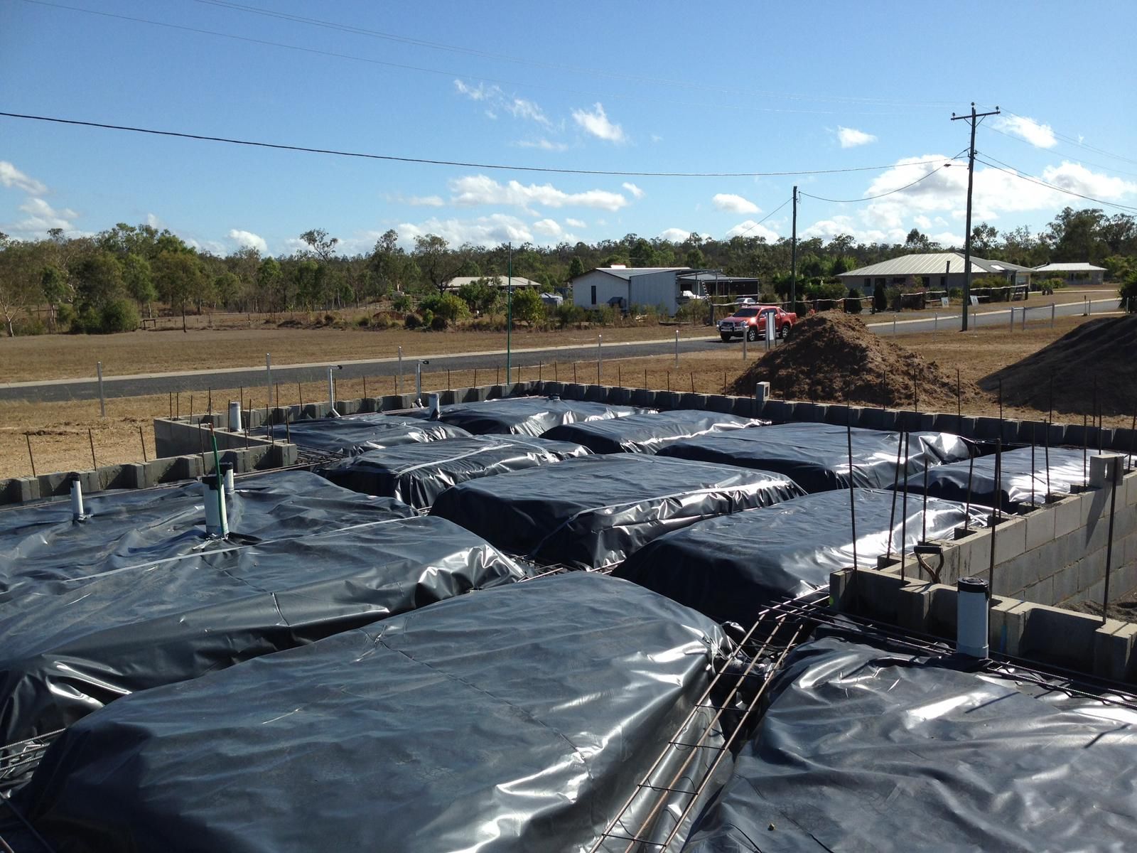 Construction Site With Black Tarp Covering Forms for a Concrete Slab — Ericson Constructions in Mareeba, QLD