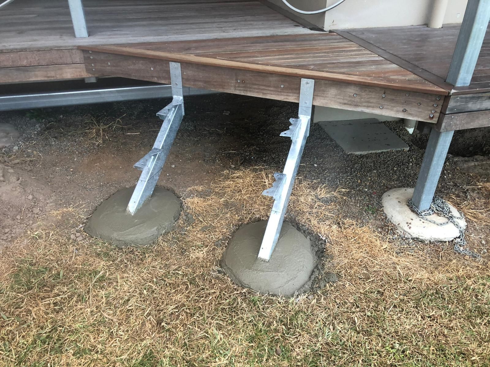 Two Metal Deck Supports Set in Concrete on Grassy Ground — Ericson Constructions in Mareeba, QLD