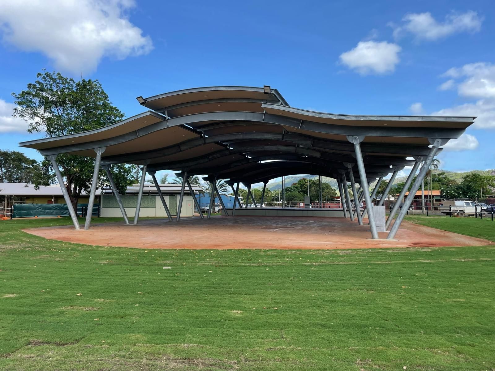 Large Outdoor Shelter With Curved Roof, Supported By Metal Beams, On A Grassy Field  — Ericson Constructions in Mareeba, QLD