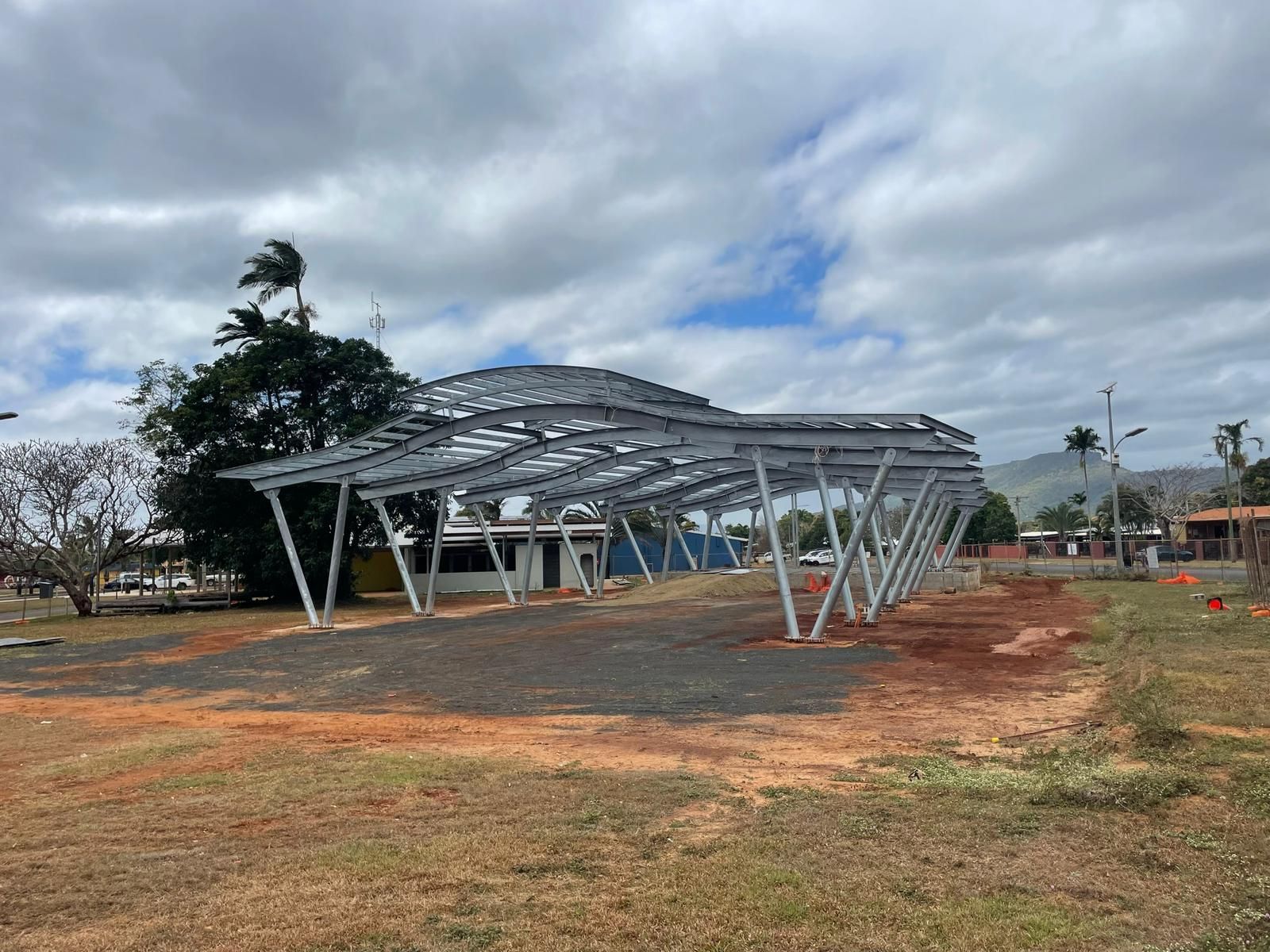 A Wooden Deck and Covered Patio Extend From a Brown House on a Sunny Day — Ericson Constructions in Mareeba, QLD