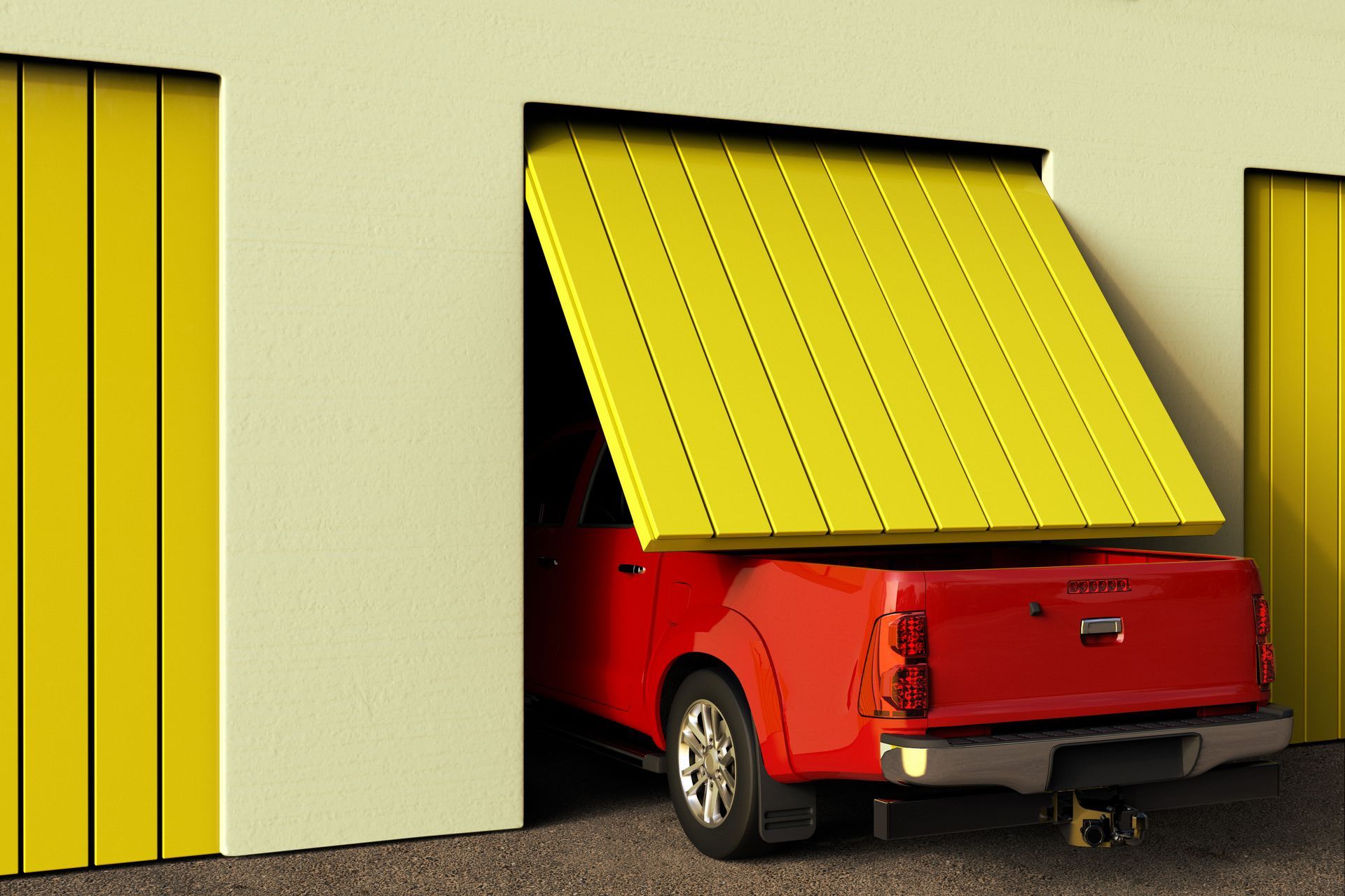 Red pickup truck partly inside a garage with a yellow door raised open