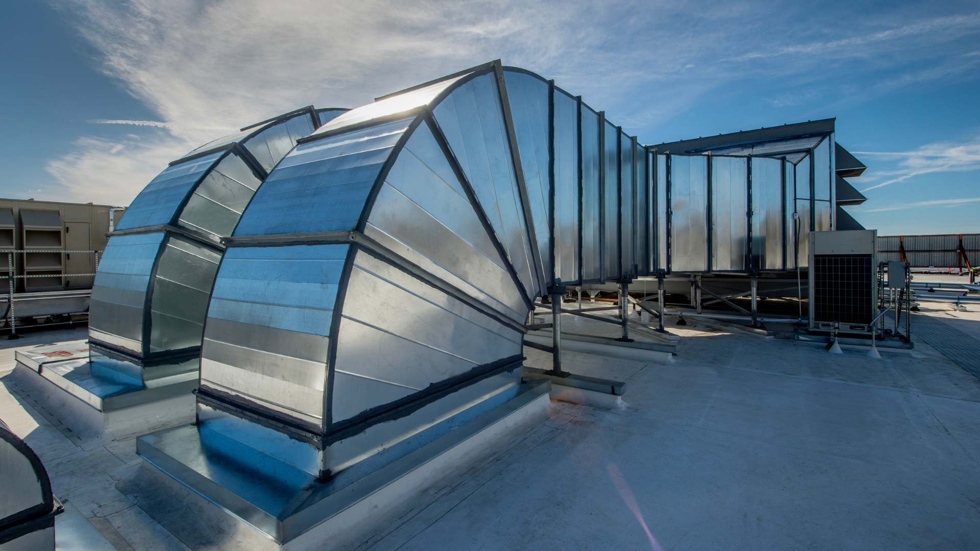 A large metal duct on the roof of a building