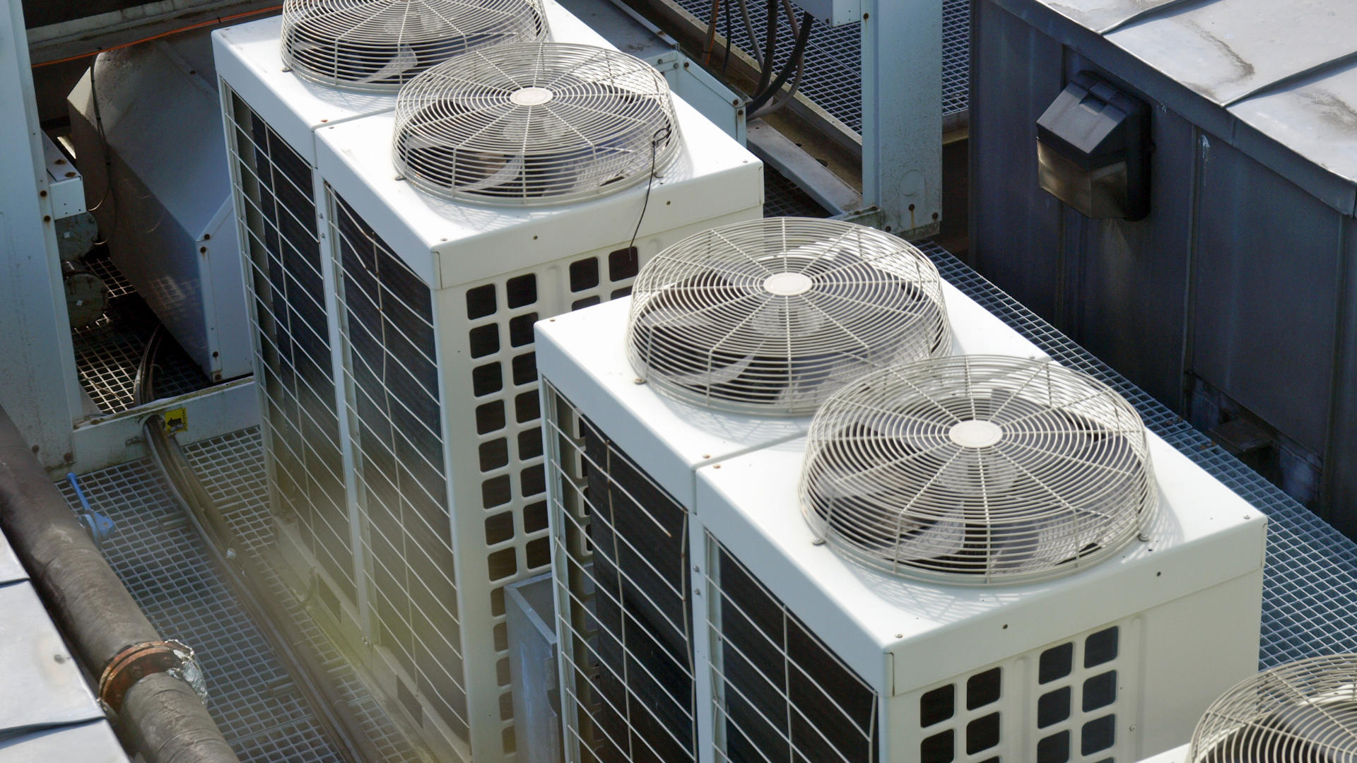 A row of air conditioners on top of a building