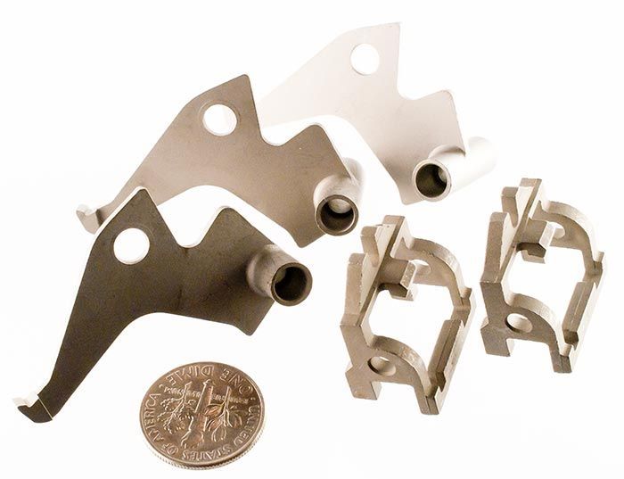 MIM parts with dime for scale