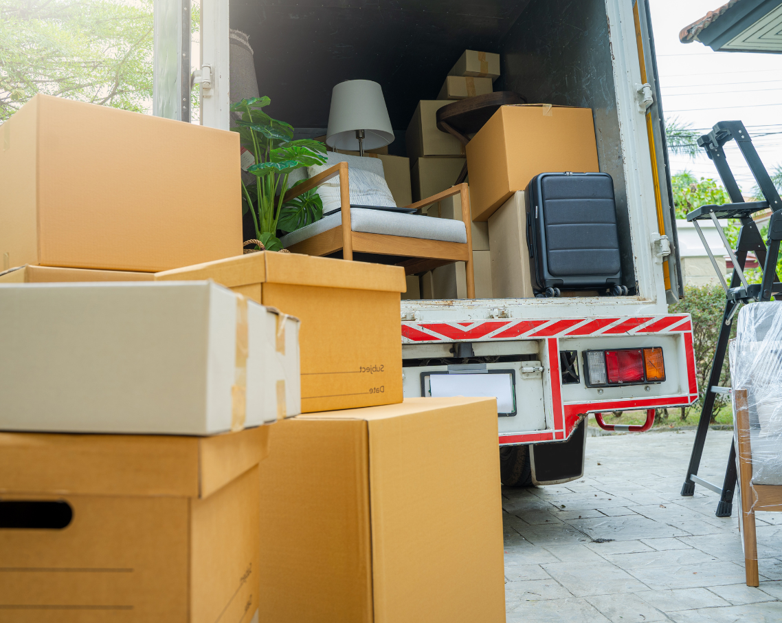 A moving truck is filled with boxes and furniture.