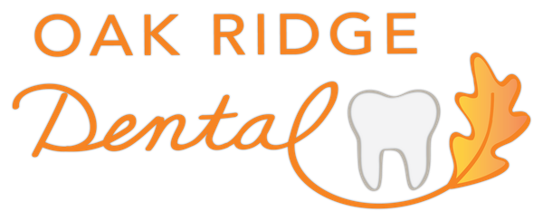 The logo for oak ridge dental shows a tooth and a leaf.