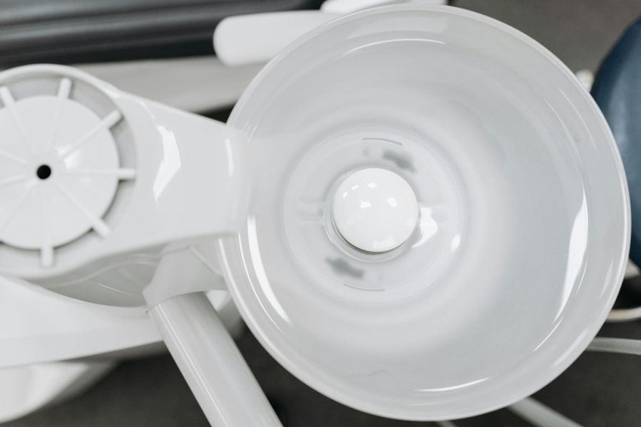 A close up of a dental chair with a light on it.