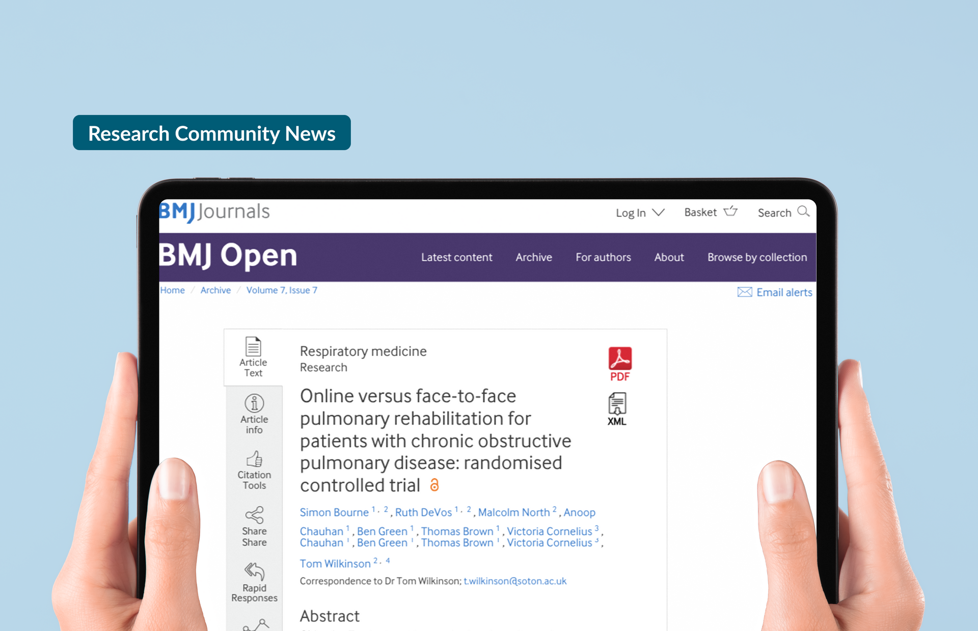 A person is holding a tablet with the BMJ website open on it.